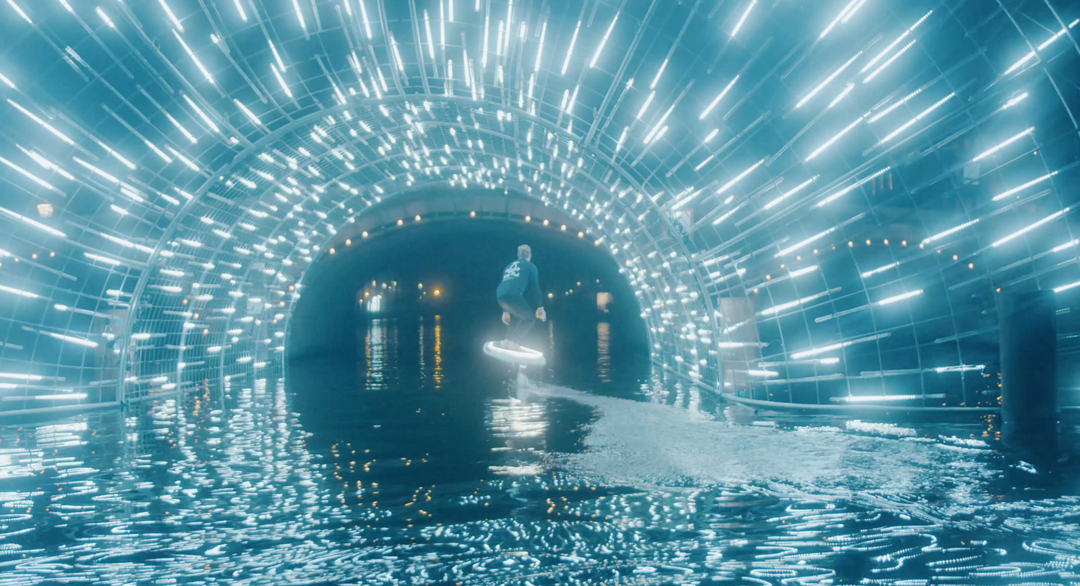 a man ride an efoil board on the Amsterdam Light Festival