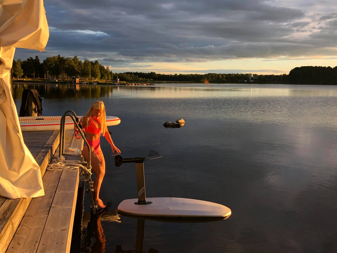 hot girl beside an eletric hydrofoil board in Sweden