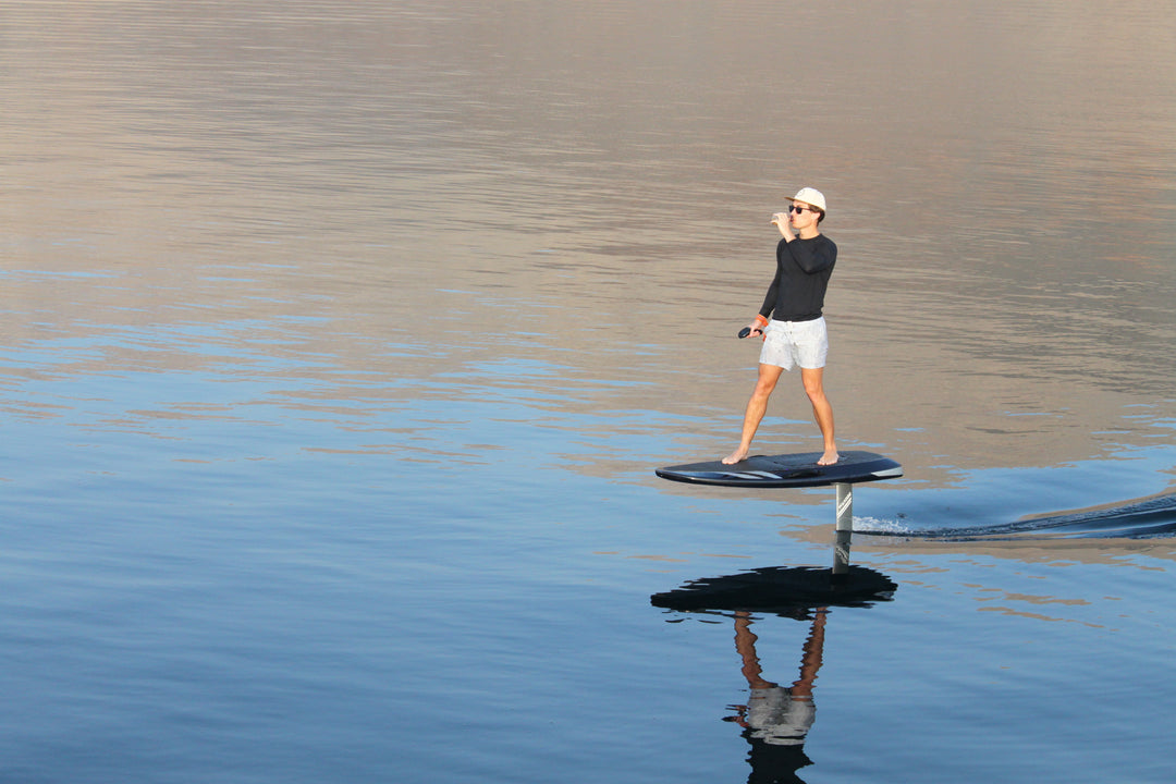 a man ride an eletric hydrofoil on the water 