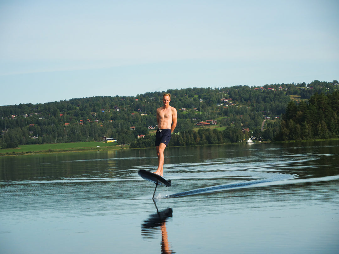 a man is learning riding a efoil board